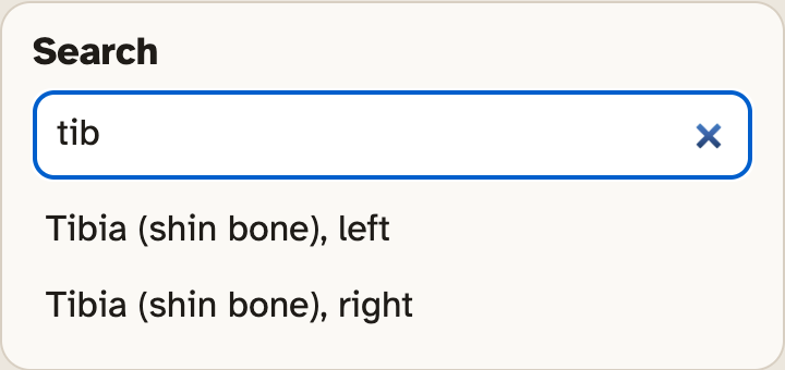 The Search box in the lab with the letters t i b typed in, and two results under it: the left tibia and the right tibia