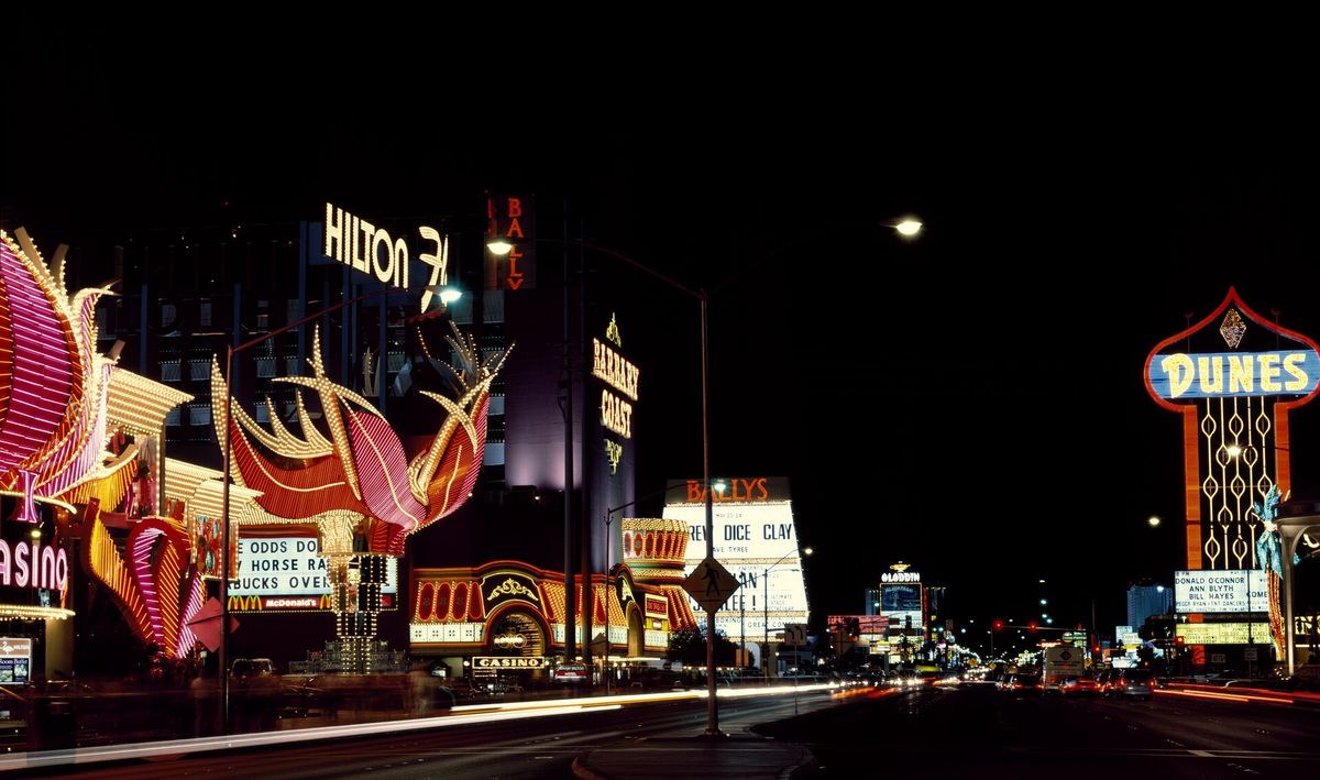 Bright glowing signs in many colors along a street in Las Vegas at night